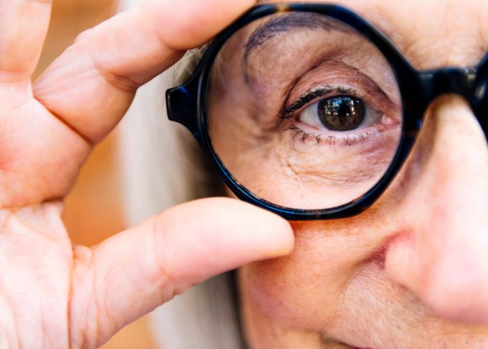 Close,Up,Of,Eye,Of,A,Senior,Woman,Putting,Glasses Close,Up,Of,Eye,Of,A,Senior,Woman,Putting,Glasses